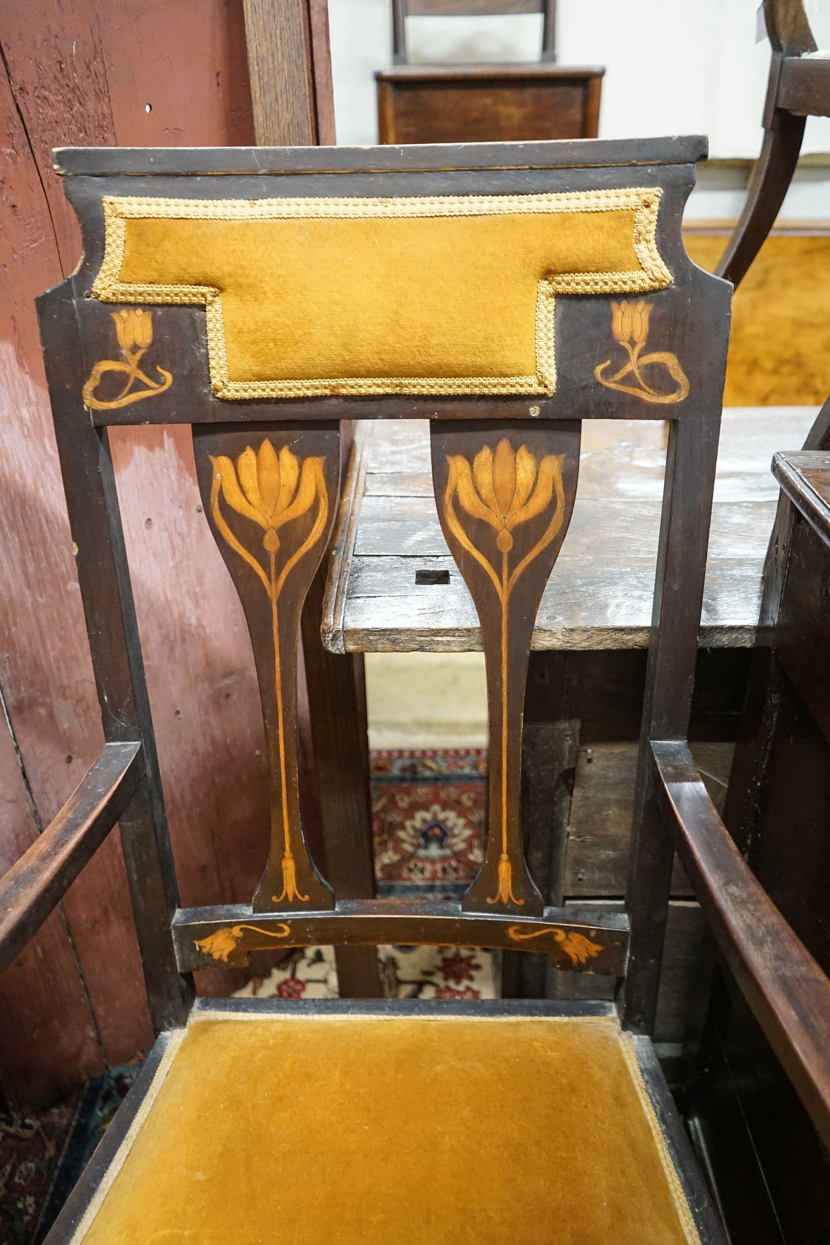 An Edwardian Art Nouveau inlaid mahogany elbow chair, width 59cm, depth 58cm, height 109cm